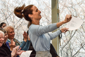 Jenna McPartland conducting the choir like Ed but with more hair flair