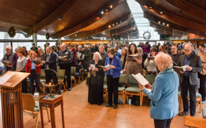 The congregation singing, "We Gather Together"
