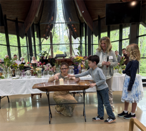 Flower Communion on May 10, 2026: Liam at candle boat